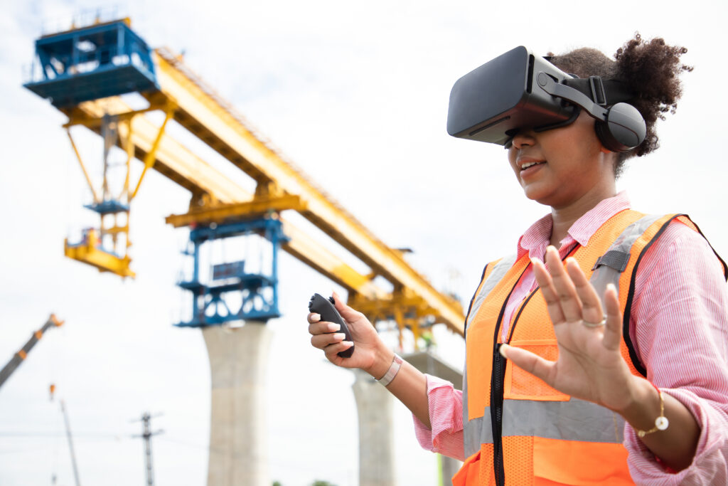 Futuristic architectural engineer woman wearing augmented reality headset and using gestures to control commercial building bridge of train at construction site.